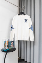 White long-sleeve sweater with blue logo graphic sleeves and crew neckline