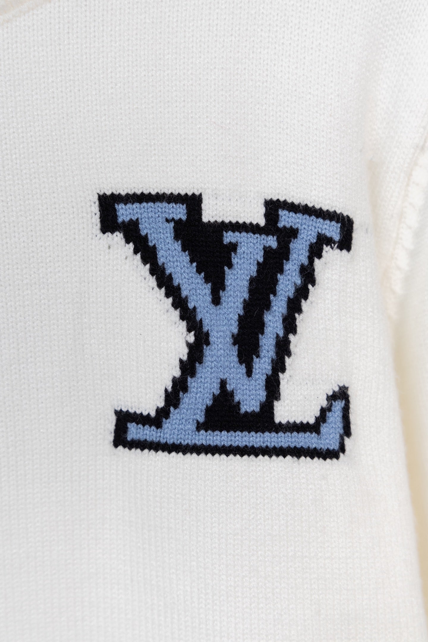 Blue LV-style logo on white knit sweater front