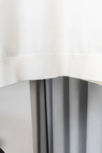 White sweater hem with ribbed knit hemline detail