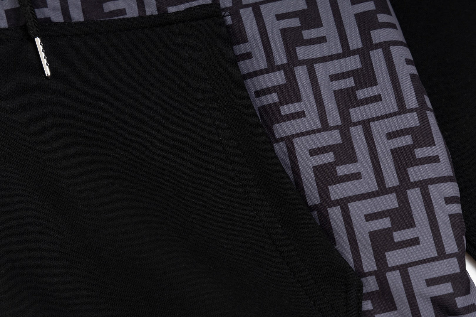 Close-up of front pocket and black zipper placket with FF monogram side panel