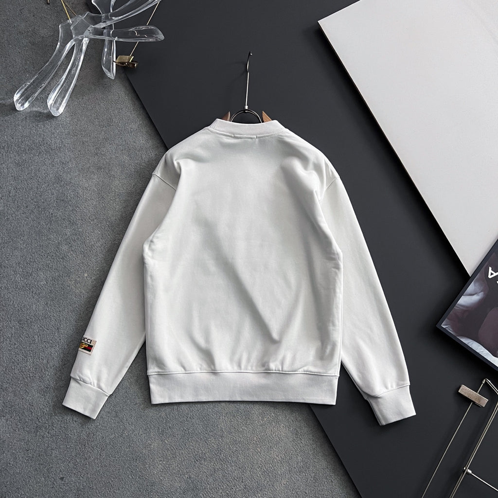 White sweatshirt back view with small sleeve cuff logo patch