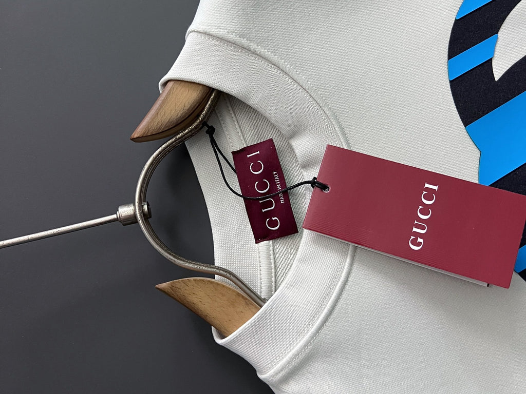 White sweatshirt collar with Gucci neck tag and brand label inside