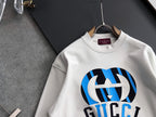 White long-sleeve sweatshirt with large blue-and-black logo graphic and crew neck