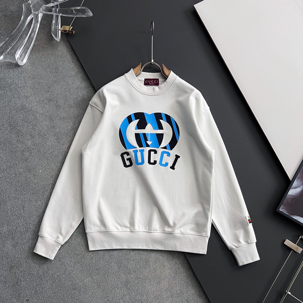 White long-sleeve sweatshirt with blue-and-black Gucci logo centered on chest