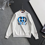 White long-sleeve sweatshirt with blue-and-black Gucci logo centered on chest