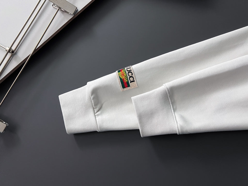 White sweatshirt with inner collar tag visible near the neckline and cuff