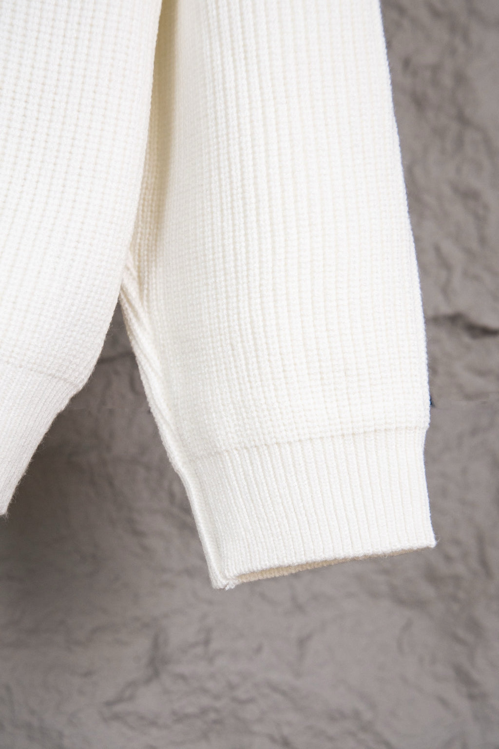 White knit sweater sleeve with ribbed cuff