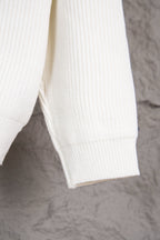 White knit sweater sleeve with ribbed cuff