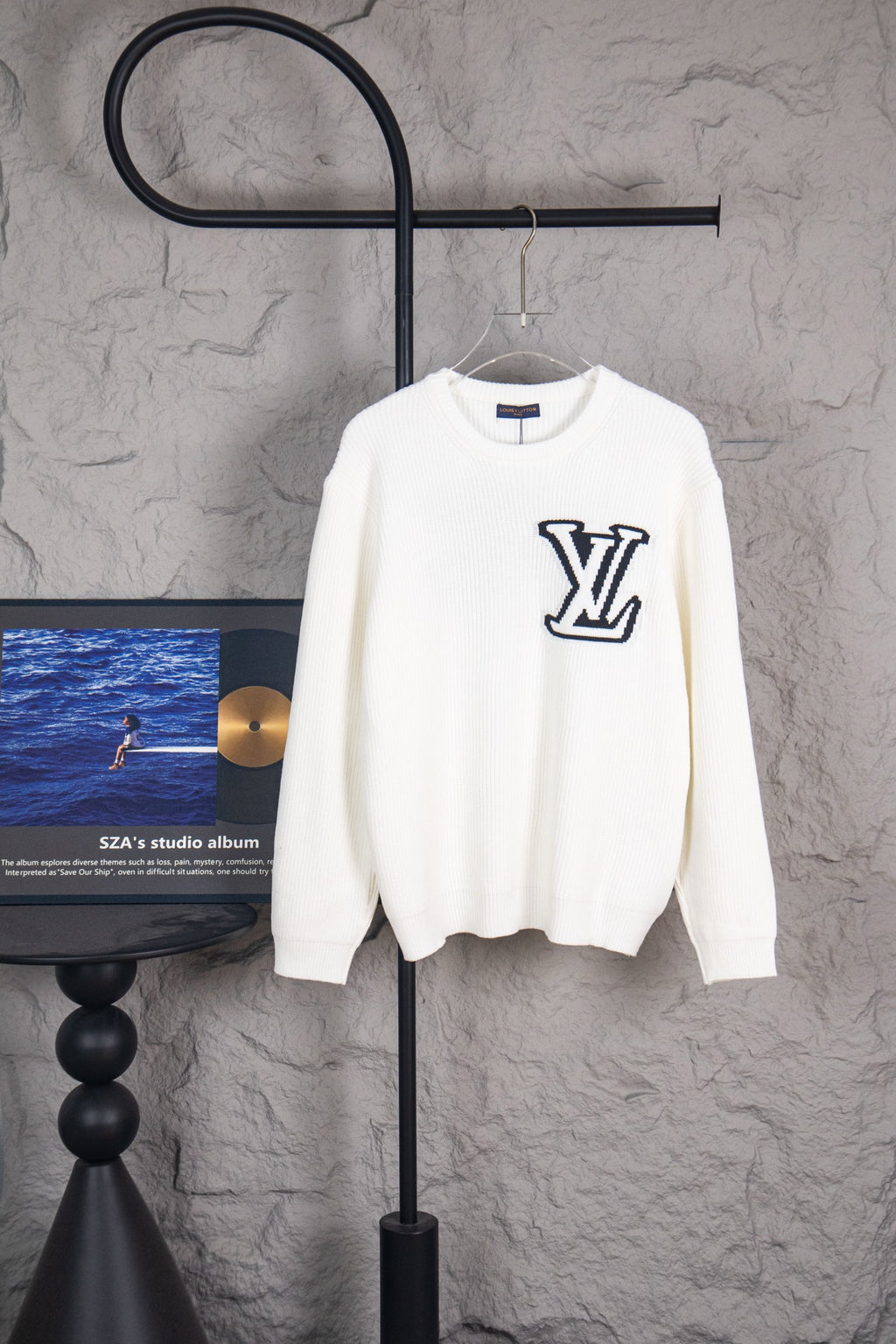 White long-sleeve knit sweater with large navy LV logo on front