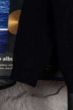 Dark navy long-sleeve sweater cuff and hem on hanger