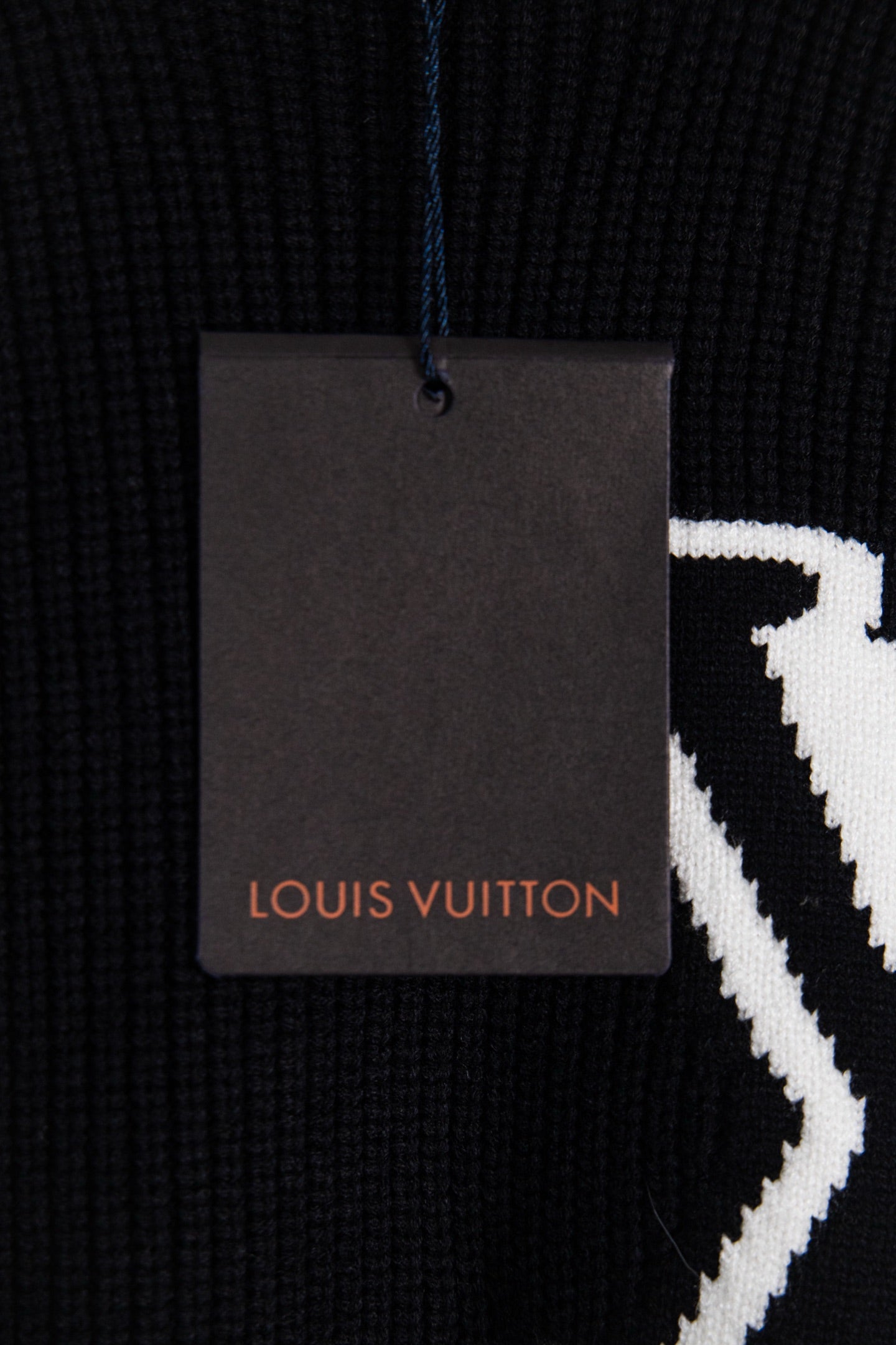 Dark navy sweater fabric with Louis Vuitton hang tag