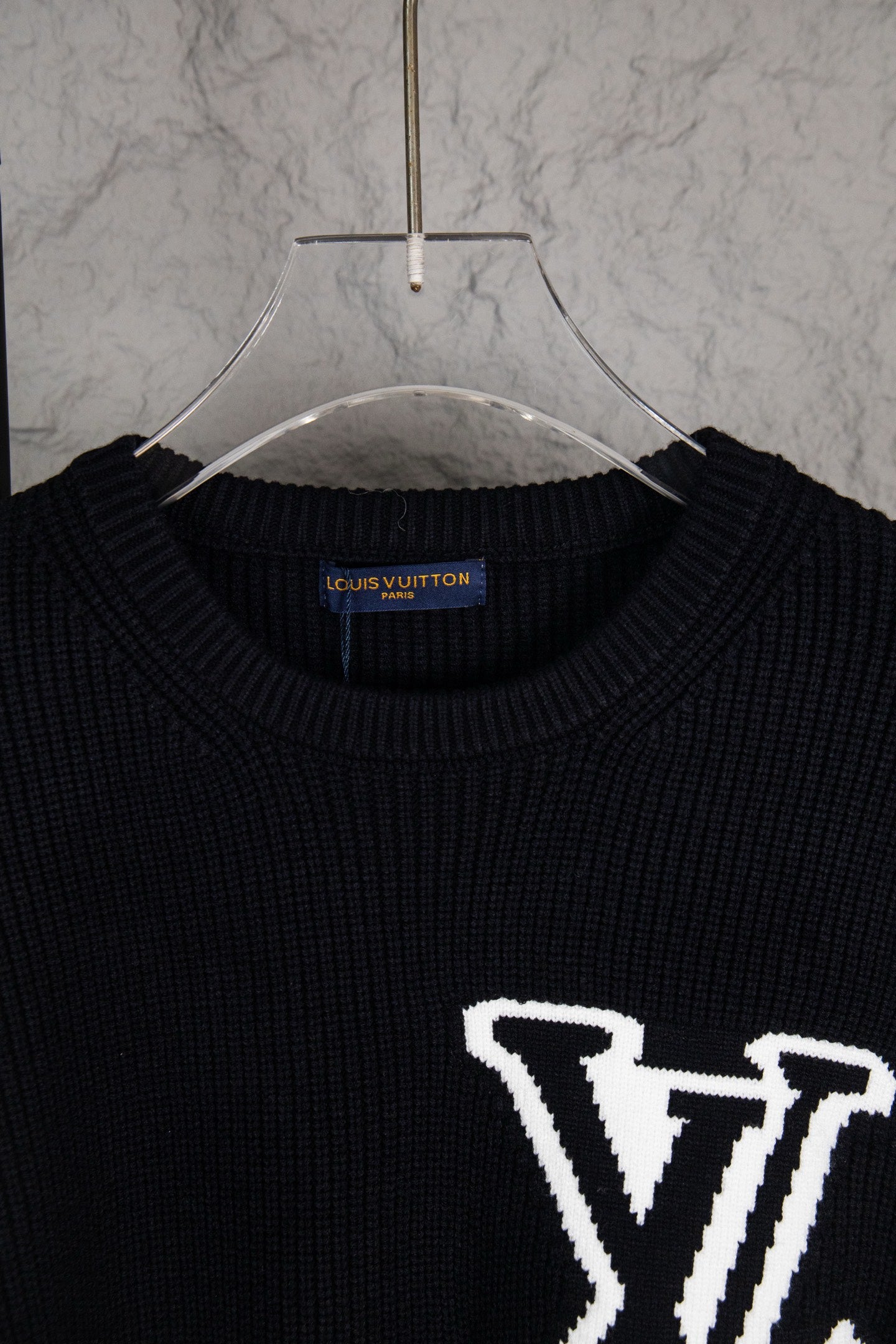 Dark navy knit sweater neckline with white LV logo detail