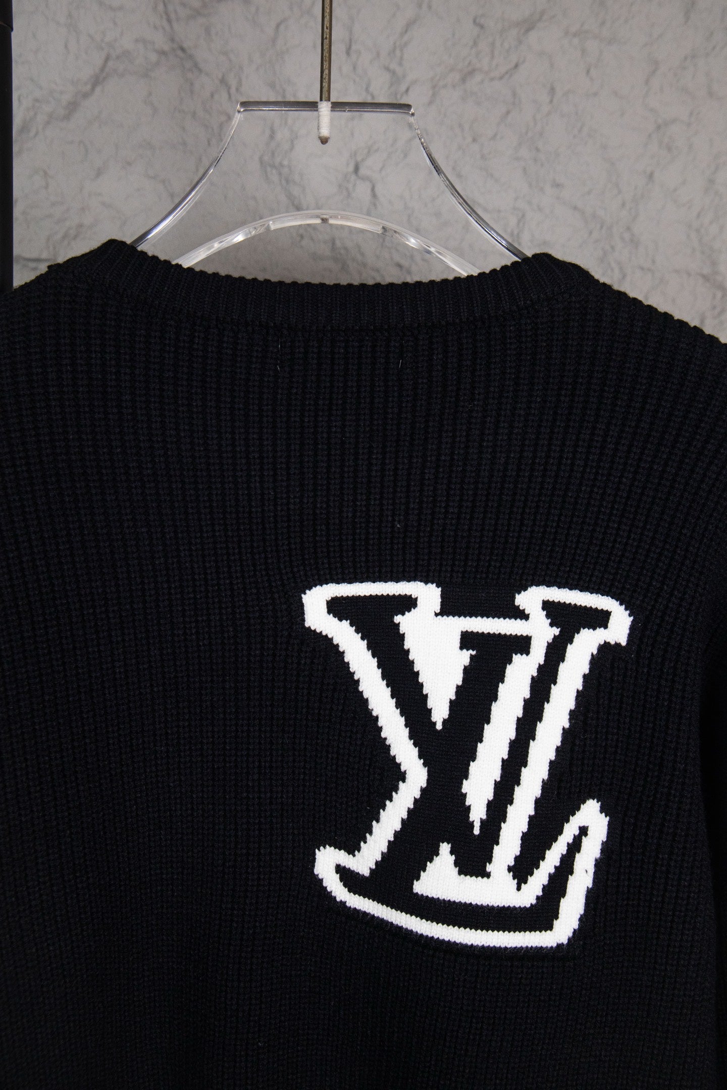 Dark navy sweater back with centered white LV logo