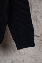 Dark navy knit sweater sleeve with ribbed cuff