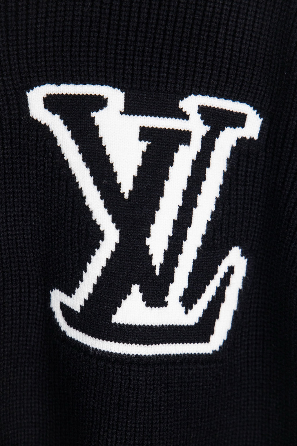 Dark navy knit sweater front with large white LV logo