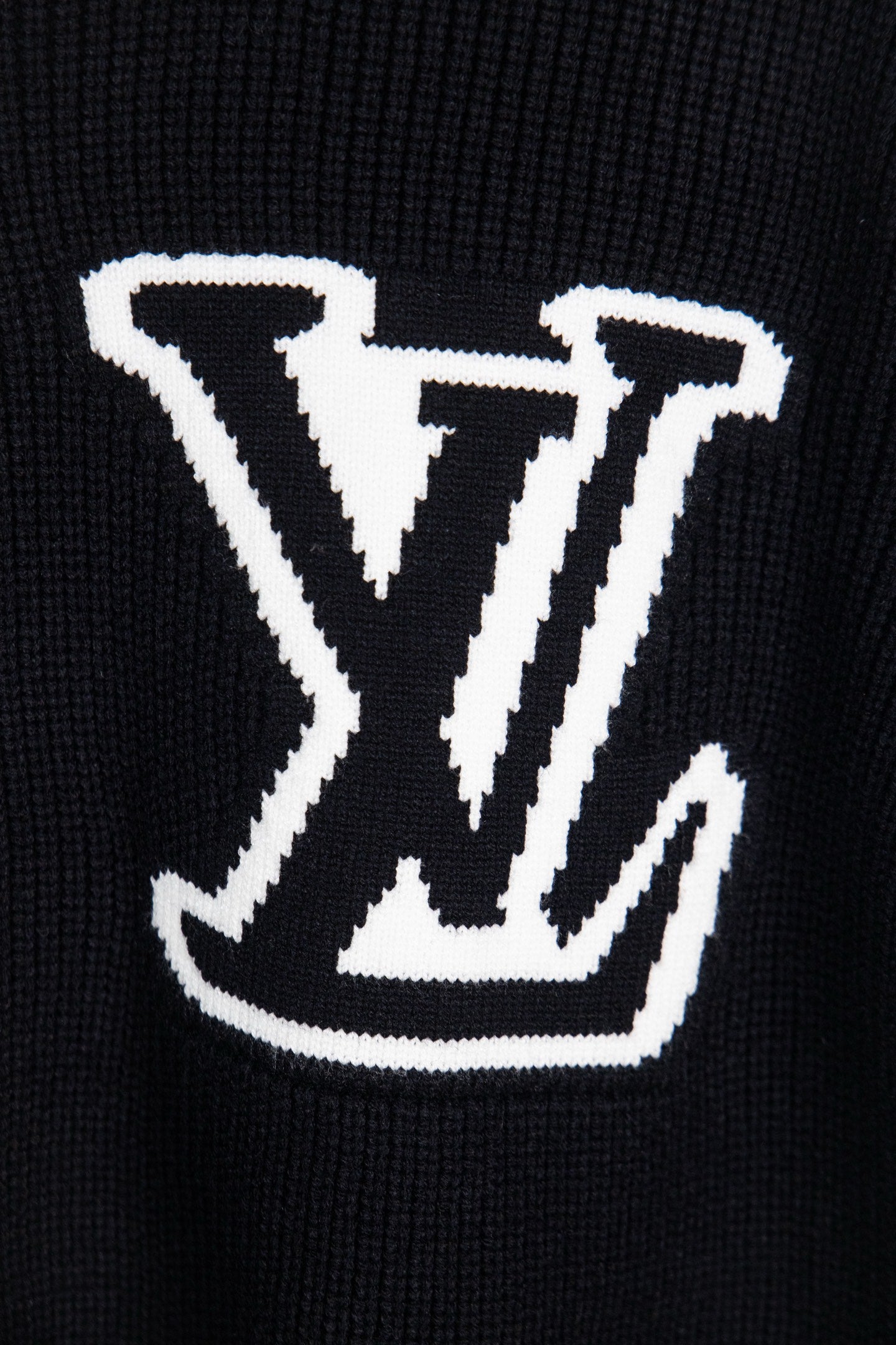 Dark navy knit sweater front with large white LV logo