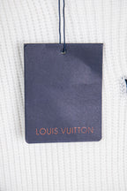 White knit sweater with navy Louis Vuitton hang tag