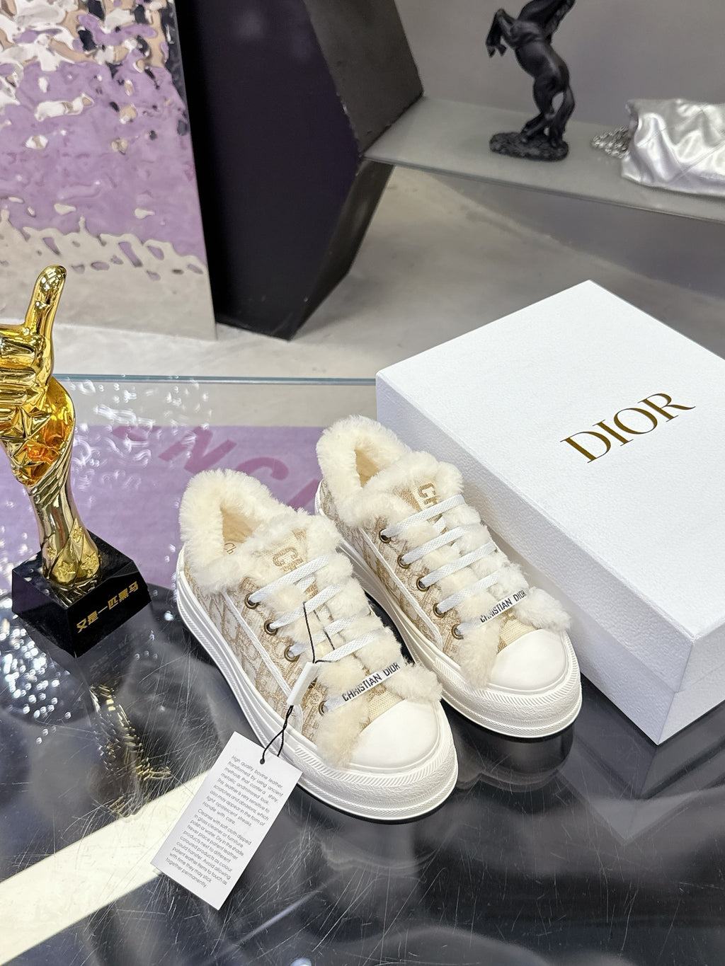 White lace-up sneakers with plush fur cuffs and beige monogram straps; rubber sole