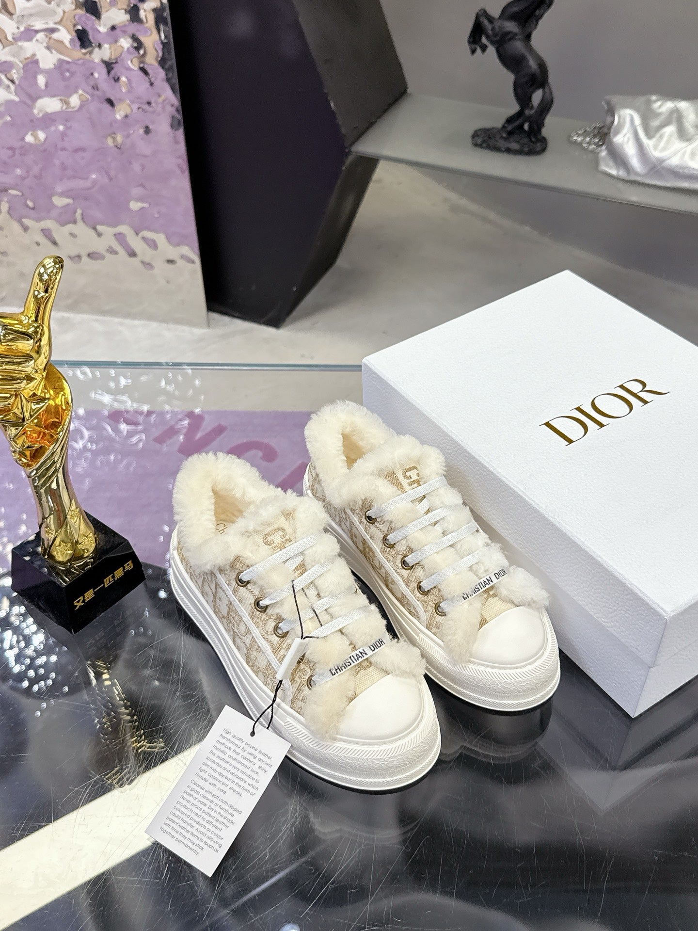 White lace-up sneakers with plush fur cuffs and beige monogram straps; rubber sole