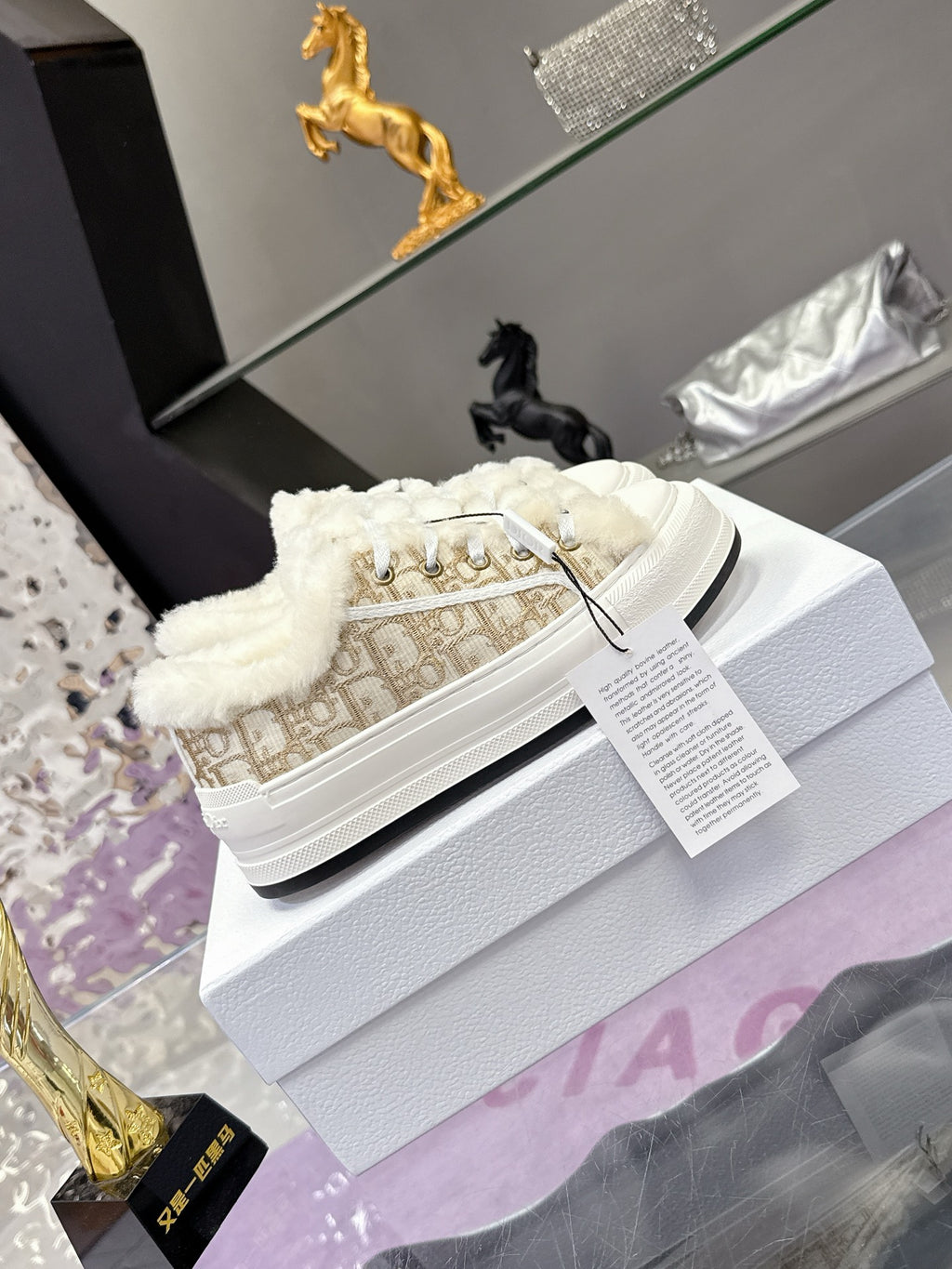 White lace-up sneakers with beige monogram canvas sides and plush white collar lining