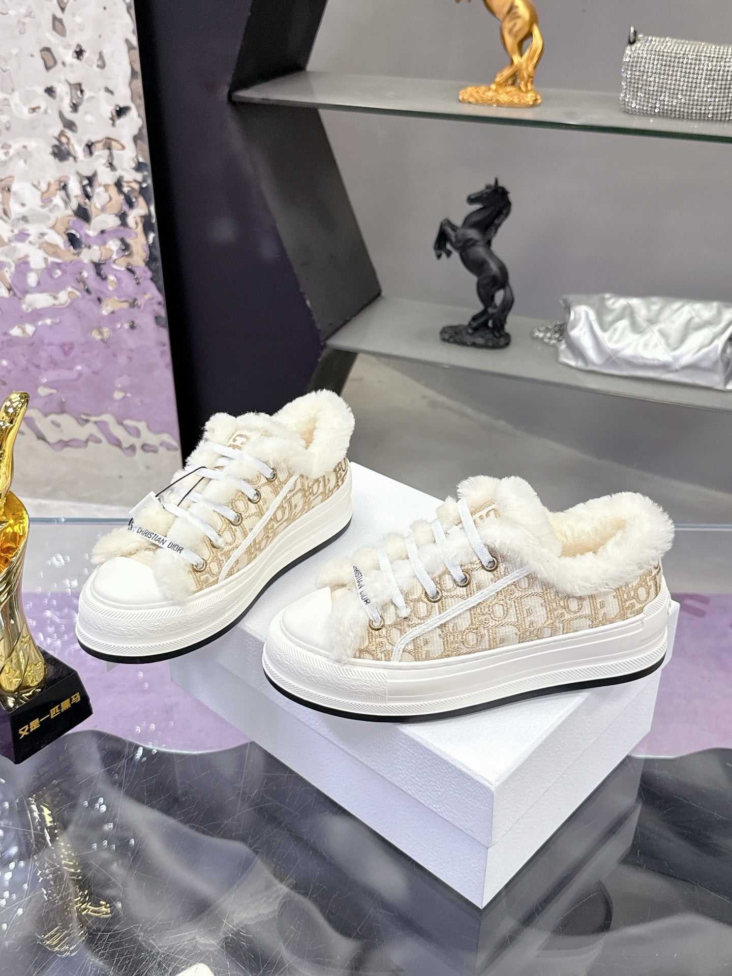 Pair of white low-top sneakers with fur-trimmed collar and patterned beige side panels