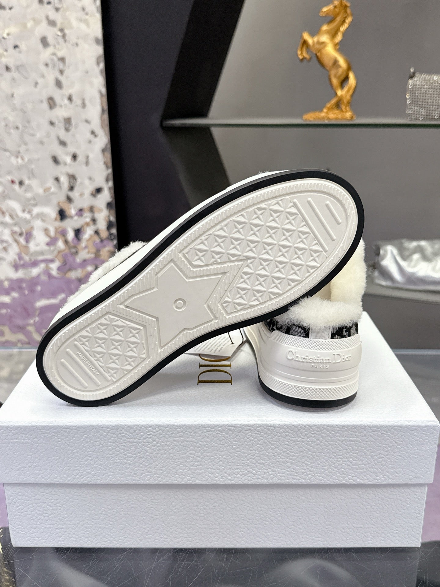 Dior sneaker outsole with textured rubber tread and white midsole on box
