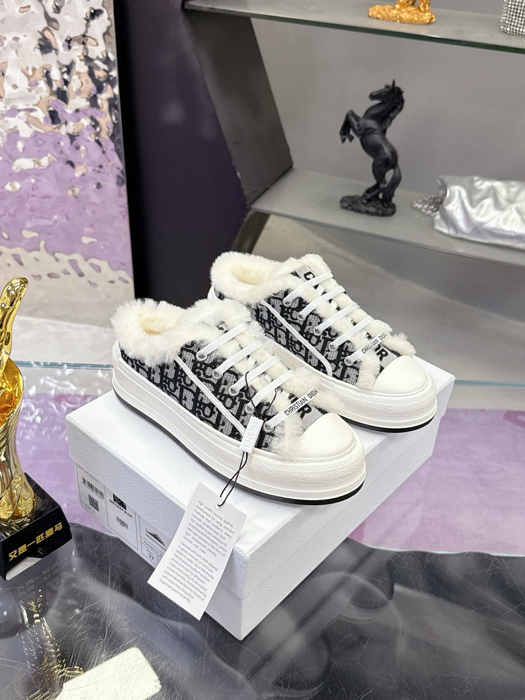 White Dior ladies sneakers with black patterned panels and fluffy white trim