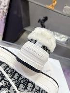 Dior sneaker heel with white midsole, black patterned side, and fluffy upper trim