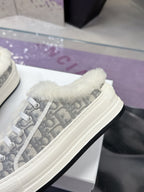 Dior women’s sneaker side view, white sole with gray monogram fabric and plush collar