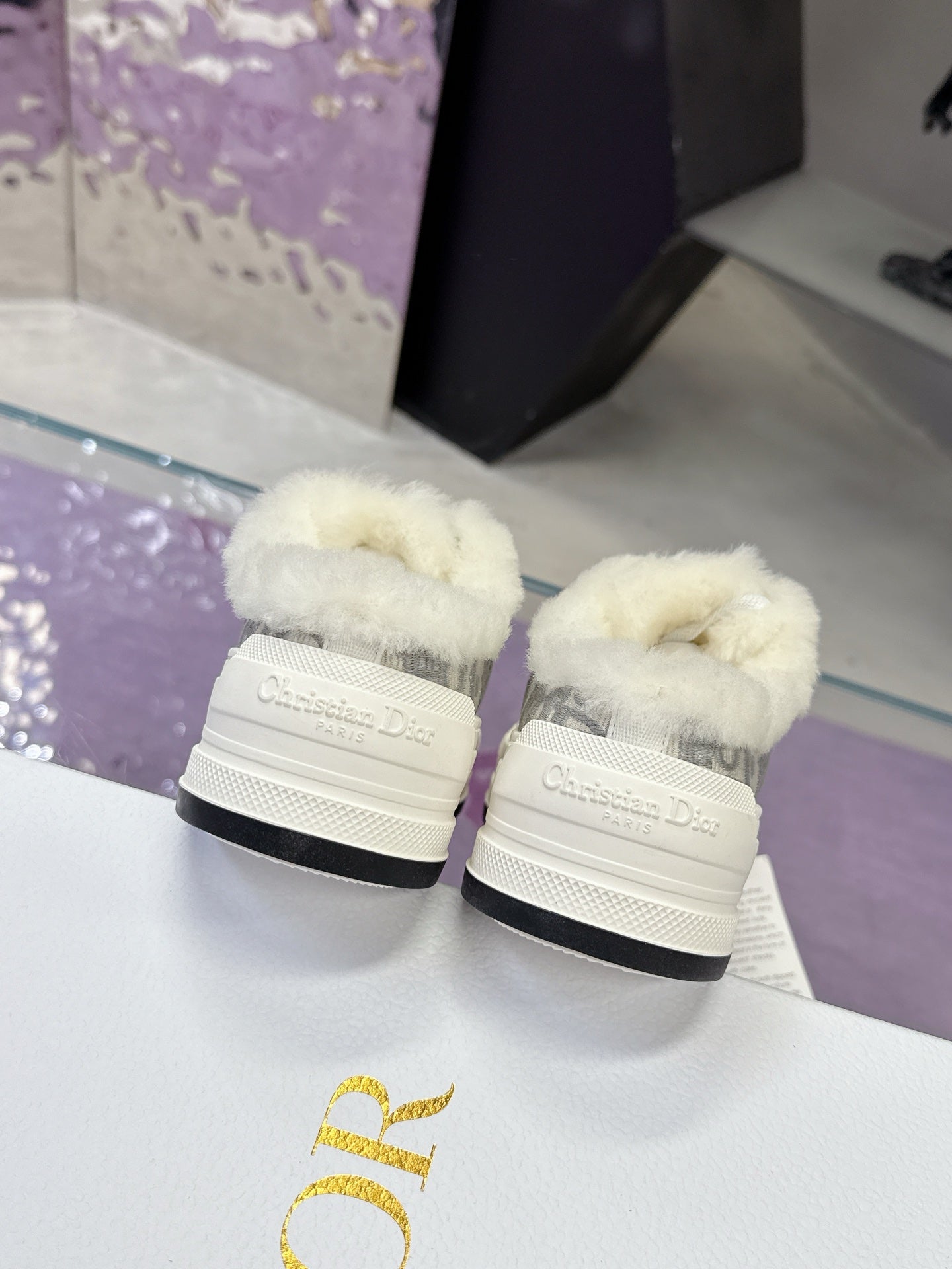Dior women’s sneaker heels, white soles with gray logo uppers and faux-fur trim