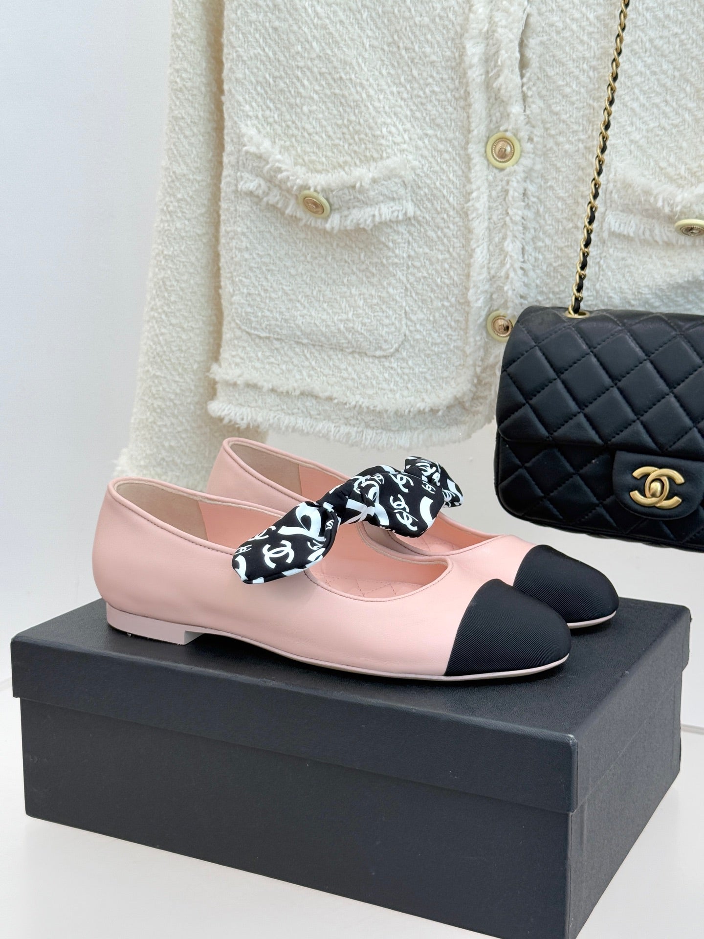 Chanel logo bow ballet flats in blush pink with black toe and heel caps