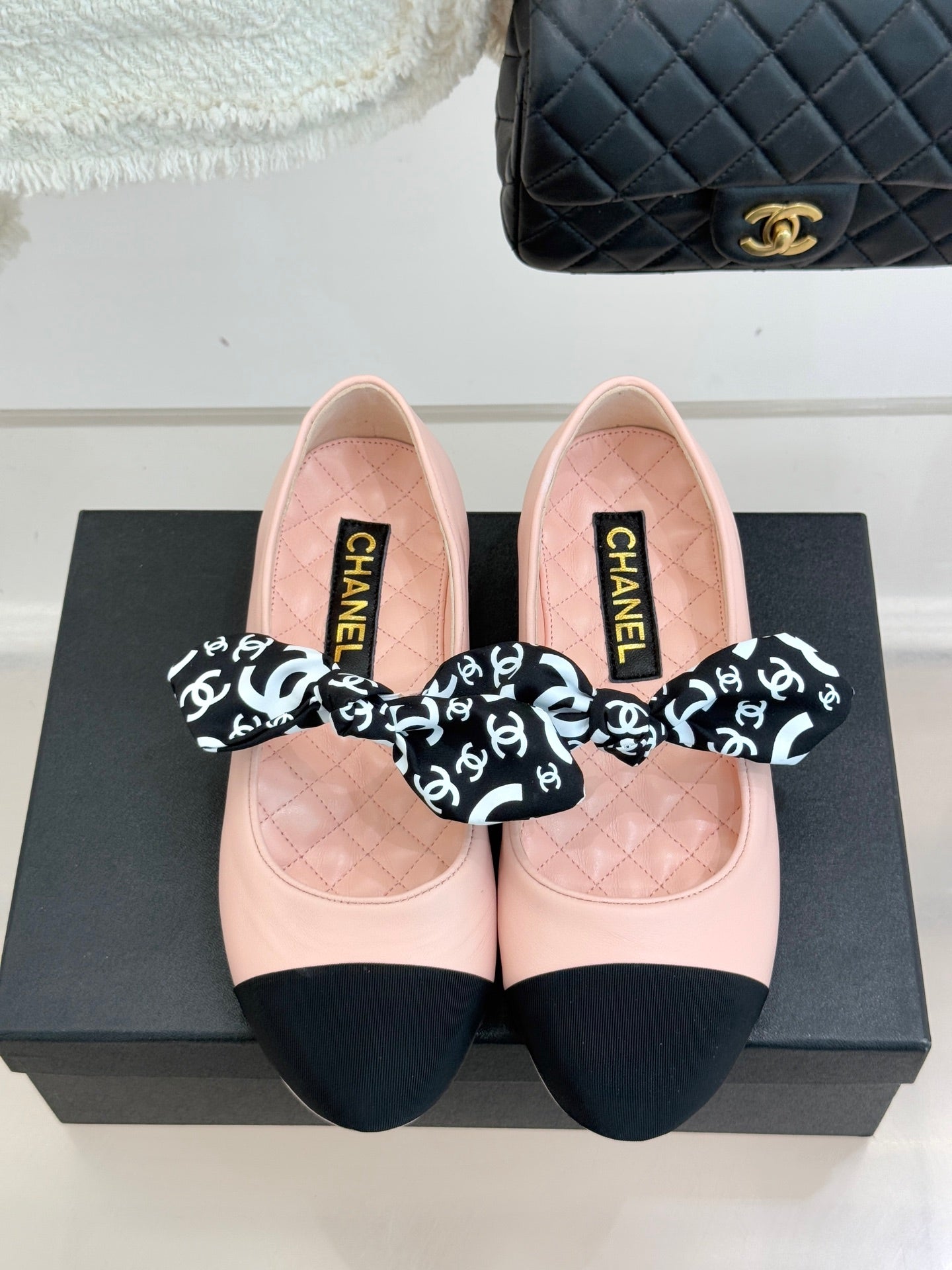Chanel logo bow ballet flats, blush pink with black toe panels and bows
