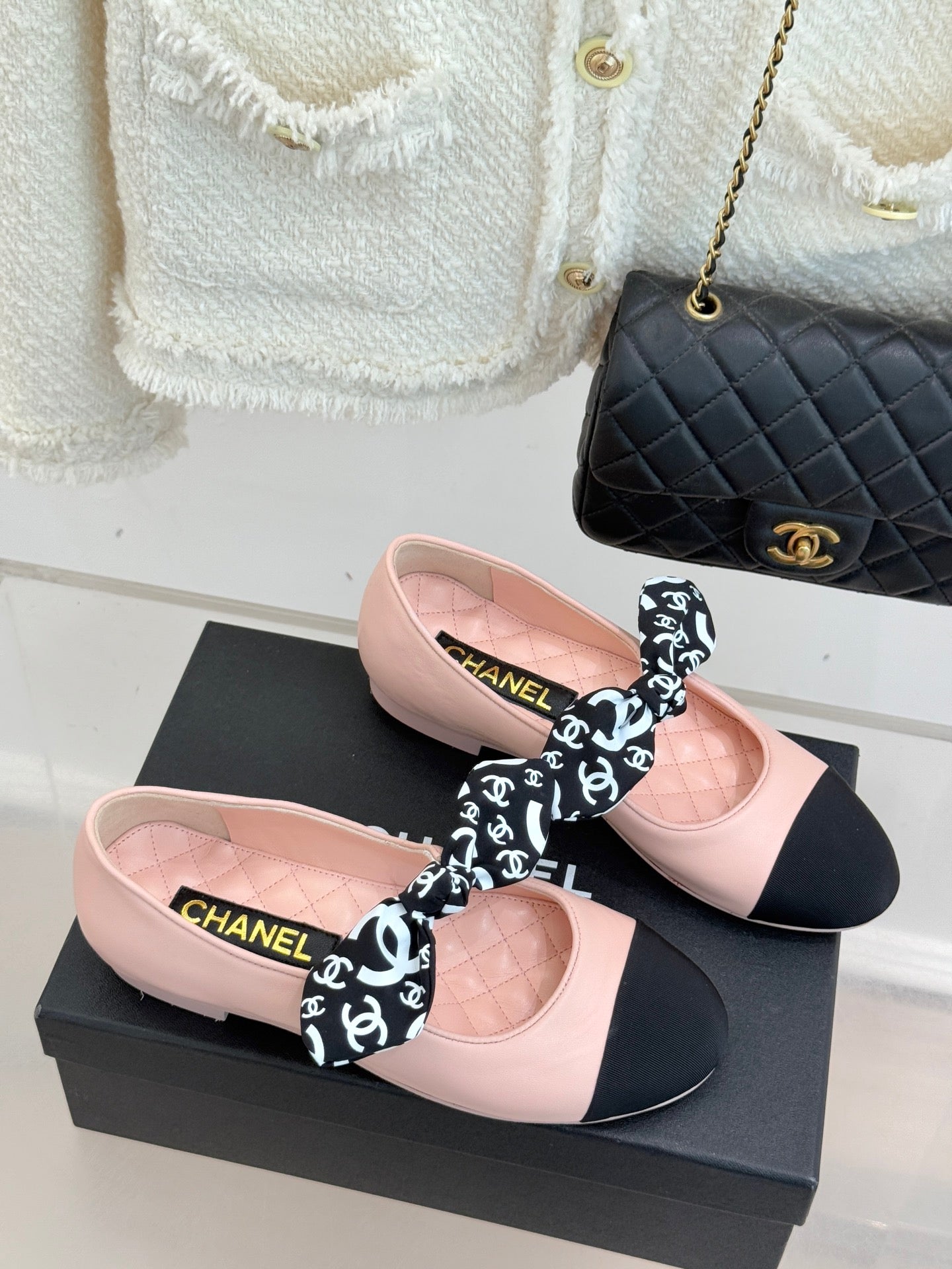 Chanel logo bow ballet flats on box: blush pink with black front and heels