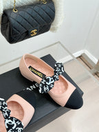 Chanel logo bow ballet flats, blush pink with black toe panels on display box