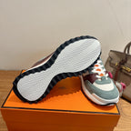 Hermes unisex luxury sneakers with striped rubber outsole and teal/burgundy upper
