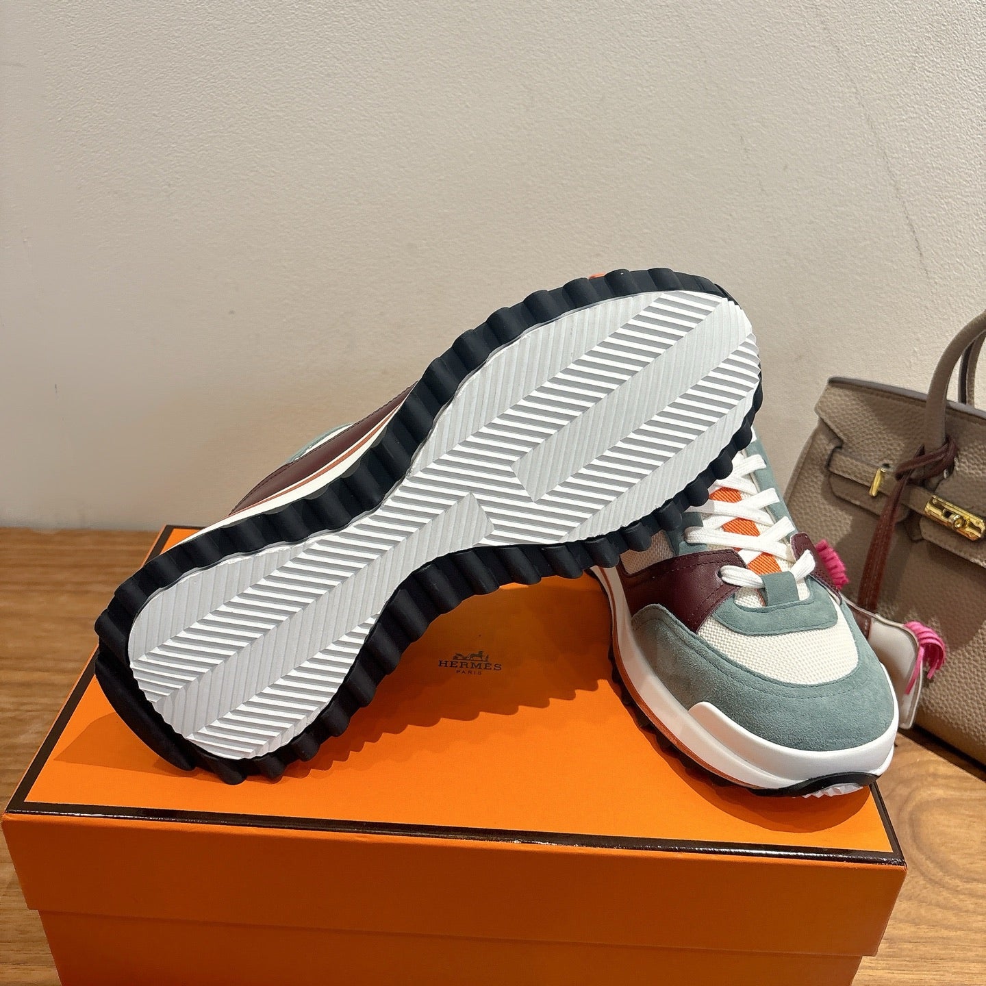 Hermes unisex luxury sneakers with striped rubber outsole and teal/burgundy upper