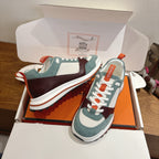 Hermes unisex luxury sneakers with teal suede panels, burgundy toe, and orange lace pull tabs