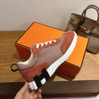 Hermes sneakers heel and side profile, brown and gray uppers, white laces, thick ridged sole