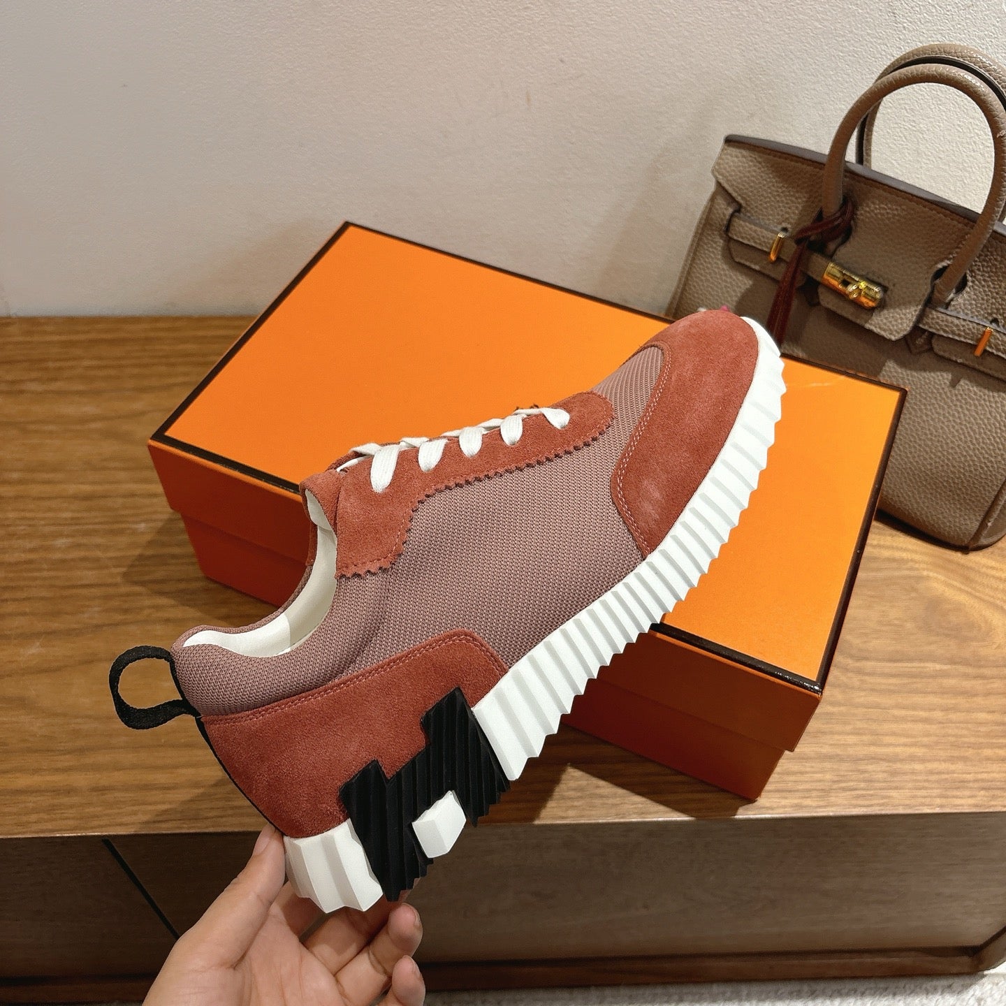 Hermes sneakers heel and side profile, brown and gray uppers, white laces, thick ridged sole