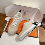 Hermes unisex sneakers in off-white with black logo stripe on side and white laces