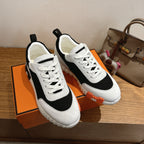White and black lace-up sneakers with orange sole edge trim, unisex luxury shoes