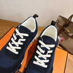 Hermes unisex sneakers, close-up of navy tongue and white lace-up detail