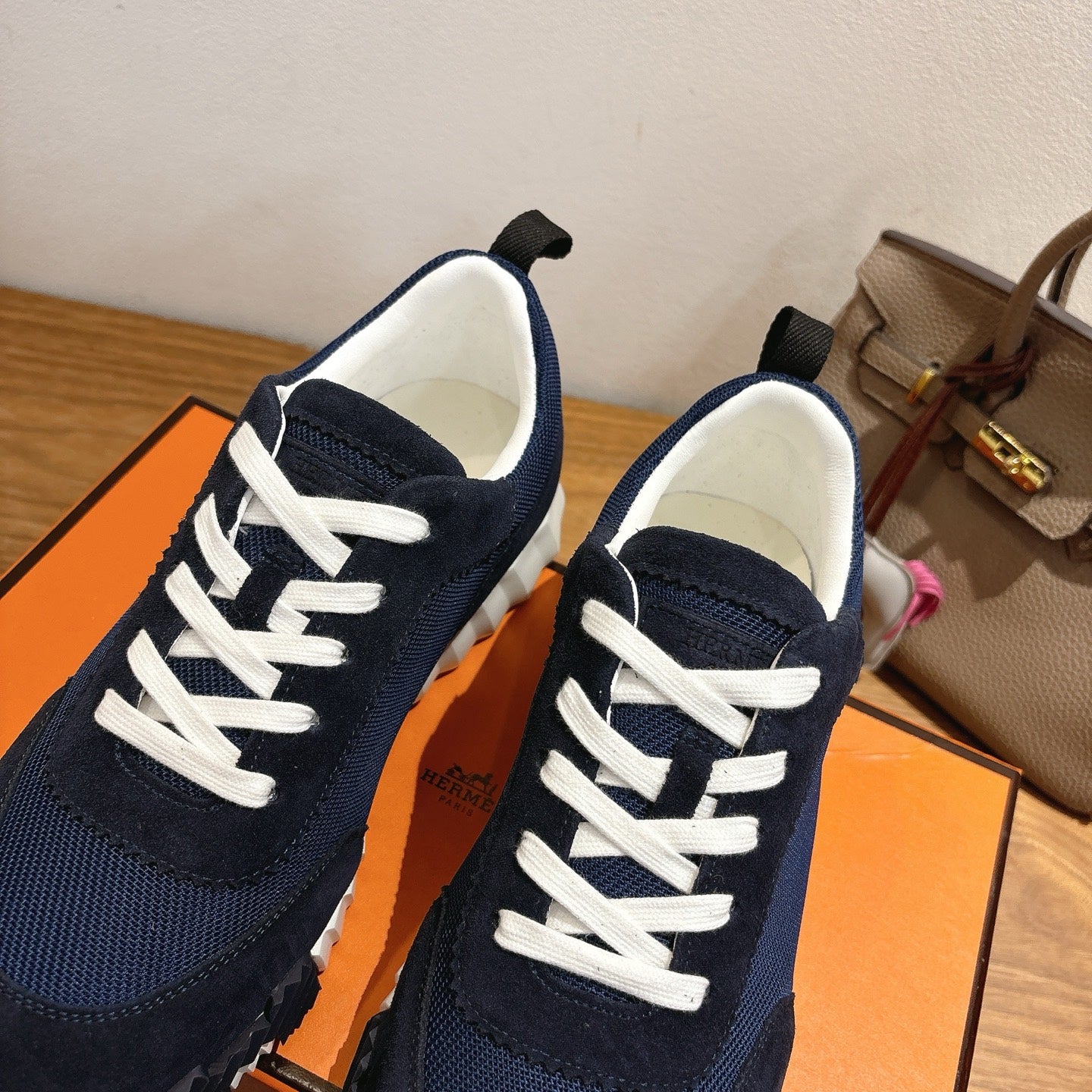 Hermes unisex sneakers, close-up of navy tongue and white lace-up detail
