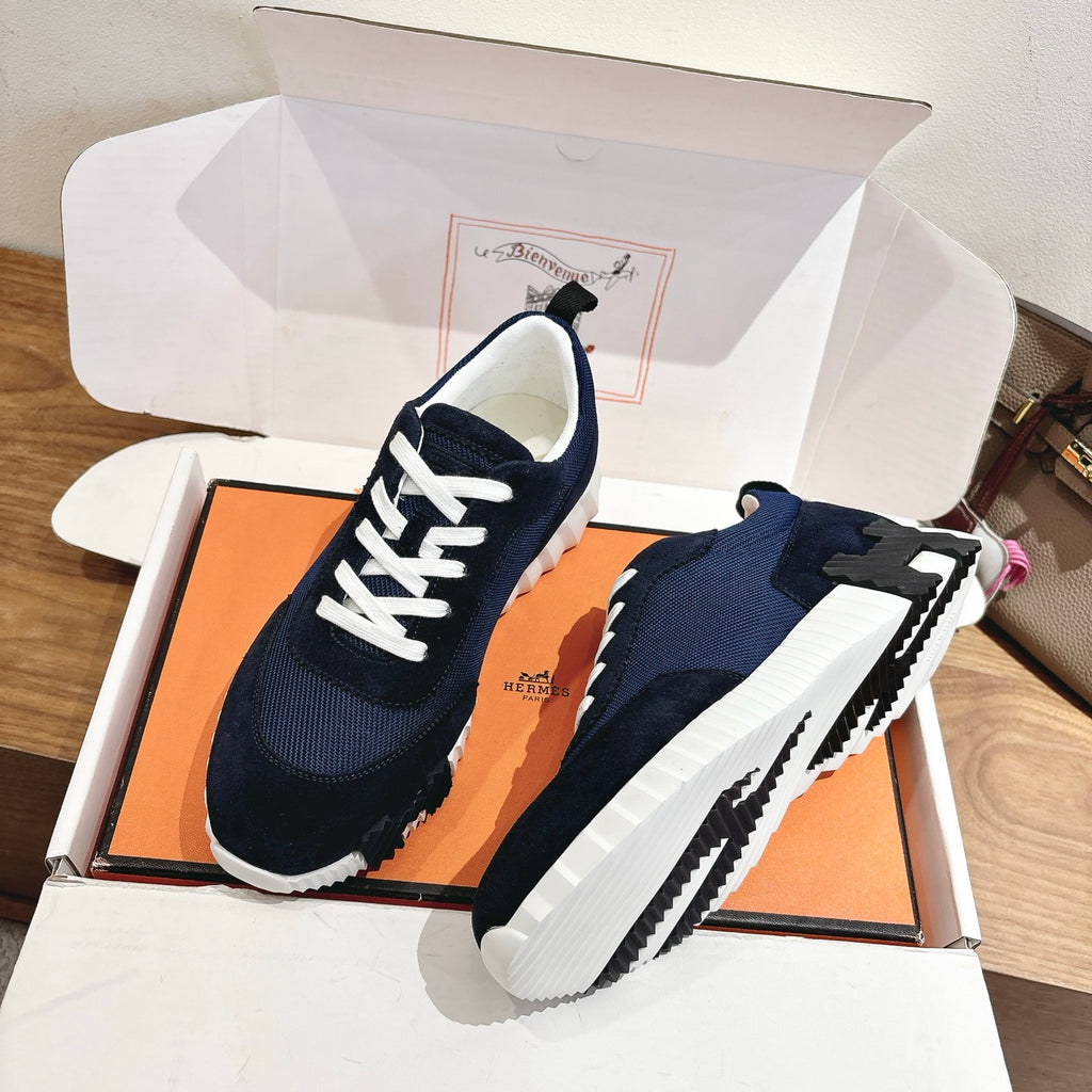 Hermes unisex sneakers with navy upper, white laces, and chunky white outsole