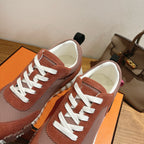 Unisex Hermes sneakers top view, white laces, brown suede toe and heel, gray knit panels