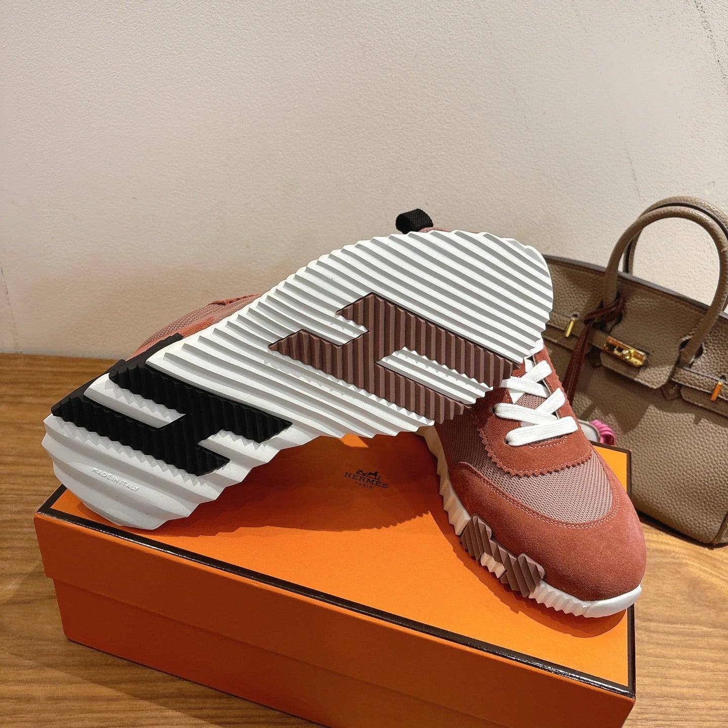 Hermes sneakers outsole view, chunky ridged tread, white sole with black accents