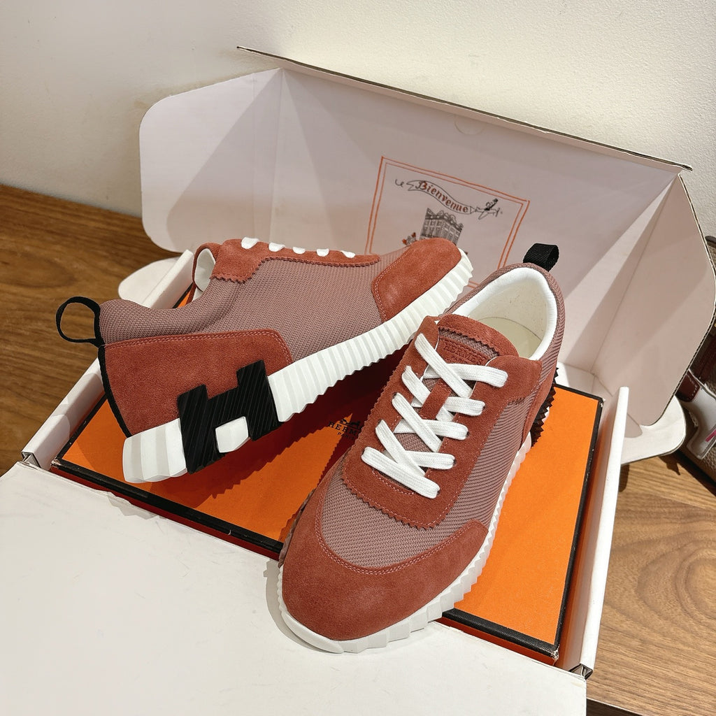 Unisex Hermes sneakers, rust-brown and gray uppers, white laces, black logo patch, ribbed sole