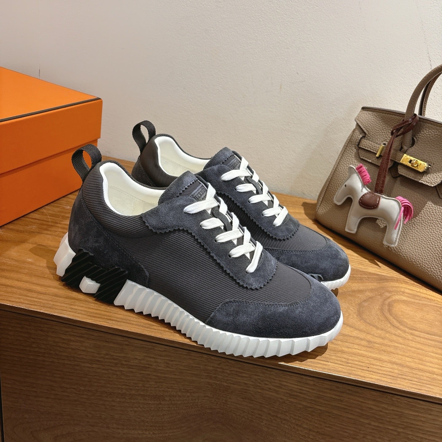 Unisex sneakers, dark knit or suede upper with white laces and thick white sole