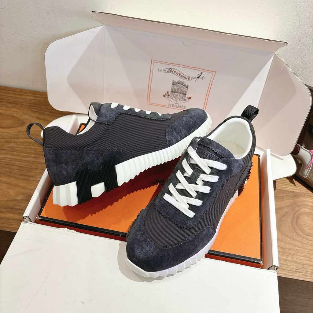 Unisex sneakers, dark upper with white laces, ridged white sole and padded collar