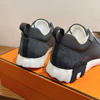 Unisex sneakers back view, dark heel panels, white midsoles and lace-up pull tabs